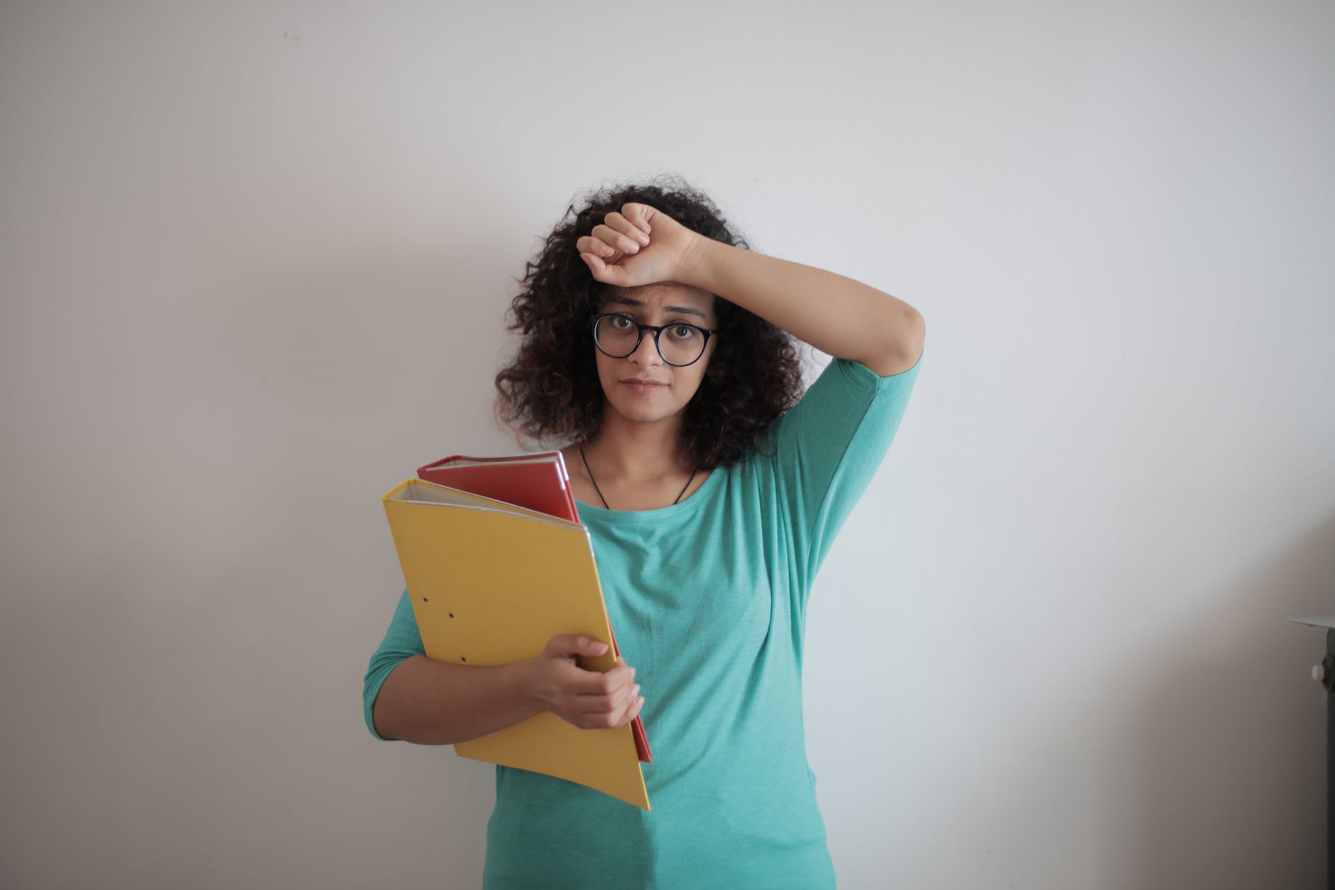 tired adult woman with papers in light modern office