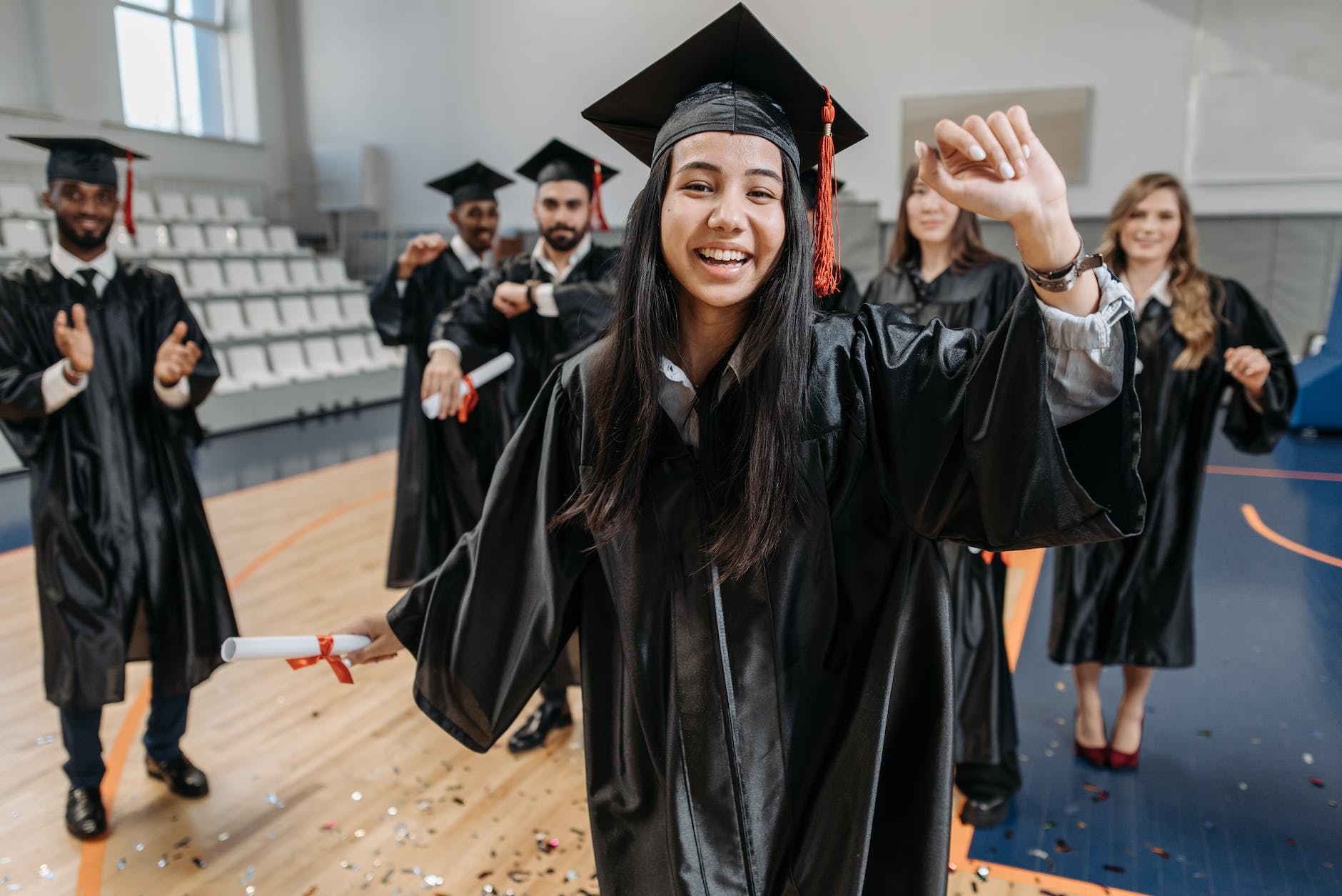 photo of happy woman in graduation gown